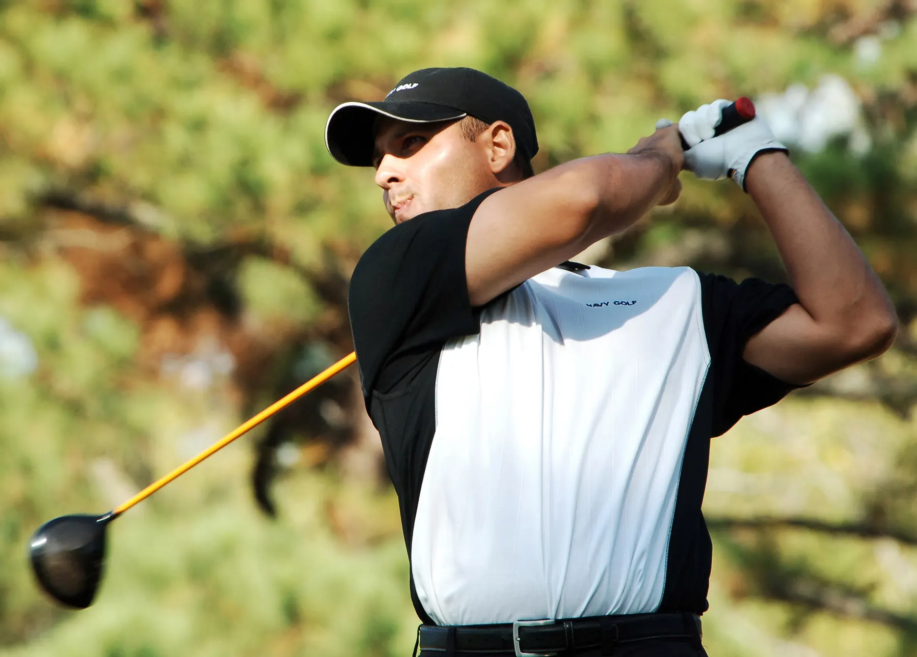 Golfer following through on a drive down the fairway